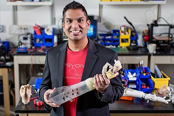 Aadeel Akhtar, an M.D./Ph.D. student at Illinois holding prosthesis. Image credit L. Brian Stauffer and Illinois News Bureau